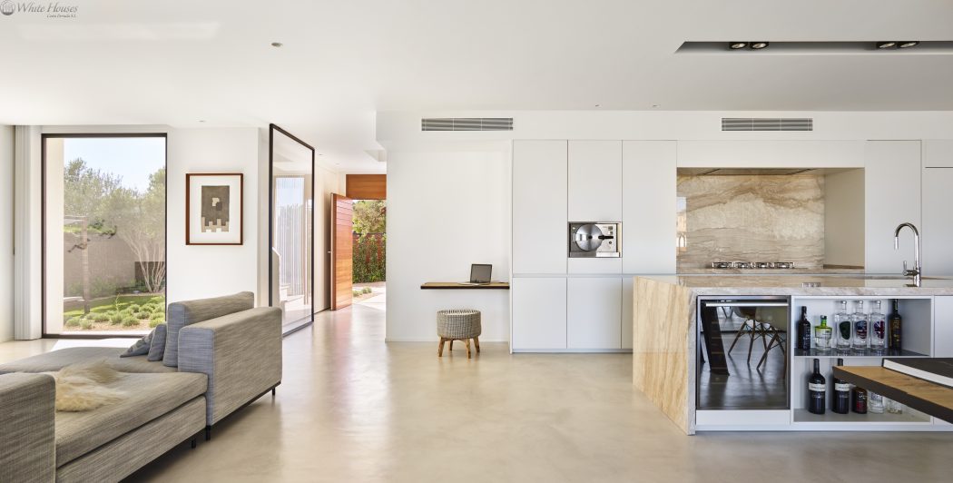 Minimalist open-plan interior with neutral tones, natural materials, and modern furniture.