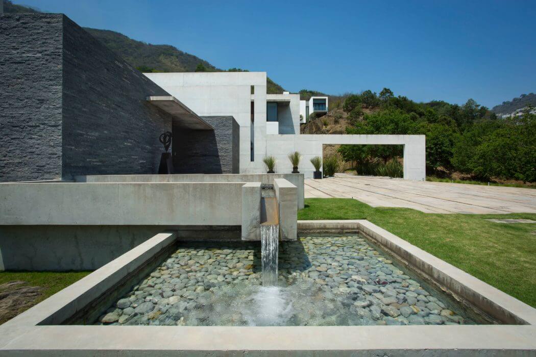 Sleek, modern architecture with a contemporary water feature and lush landscaping.