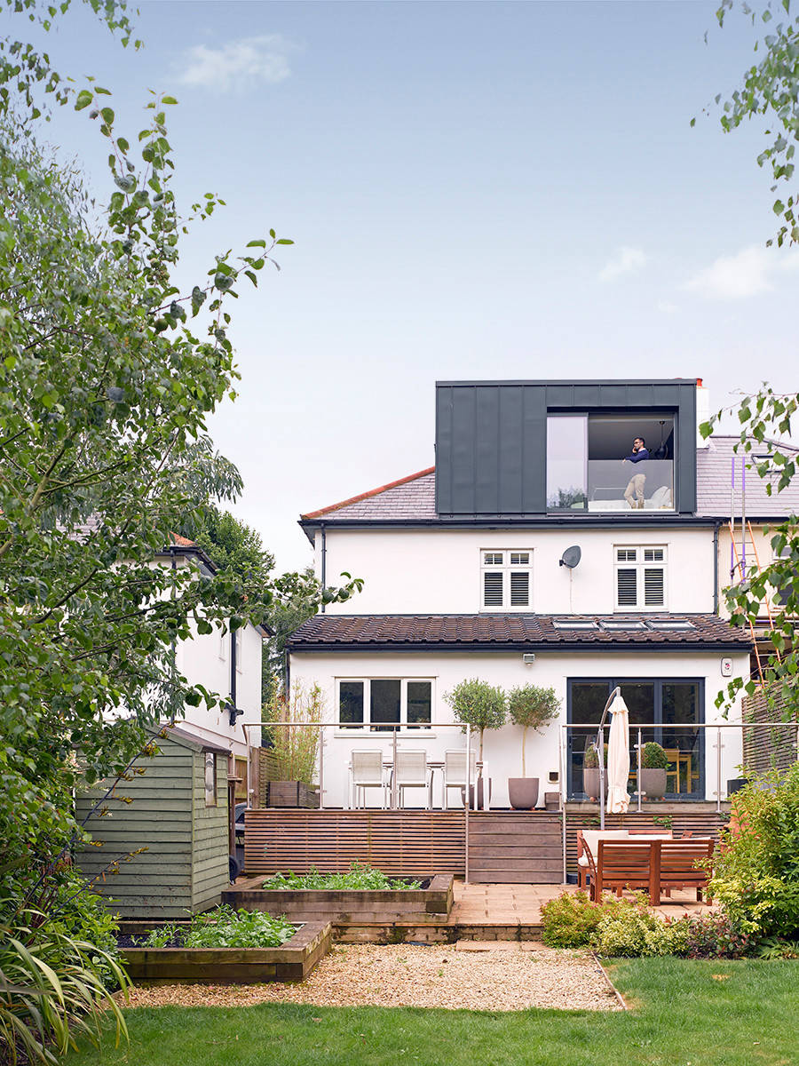 A modern addition to a traditional building, with a sleek grey facade and large windows.
