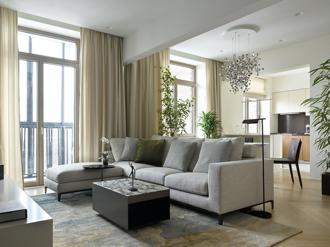 Modern living room with sectional sofa and chandelier.