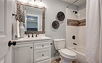 Lovely white bathroom design with reclaimed wood touches