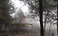 The Mushroom by ZJJZ is a cone-shaped guest house in the woods of