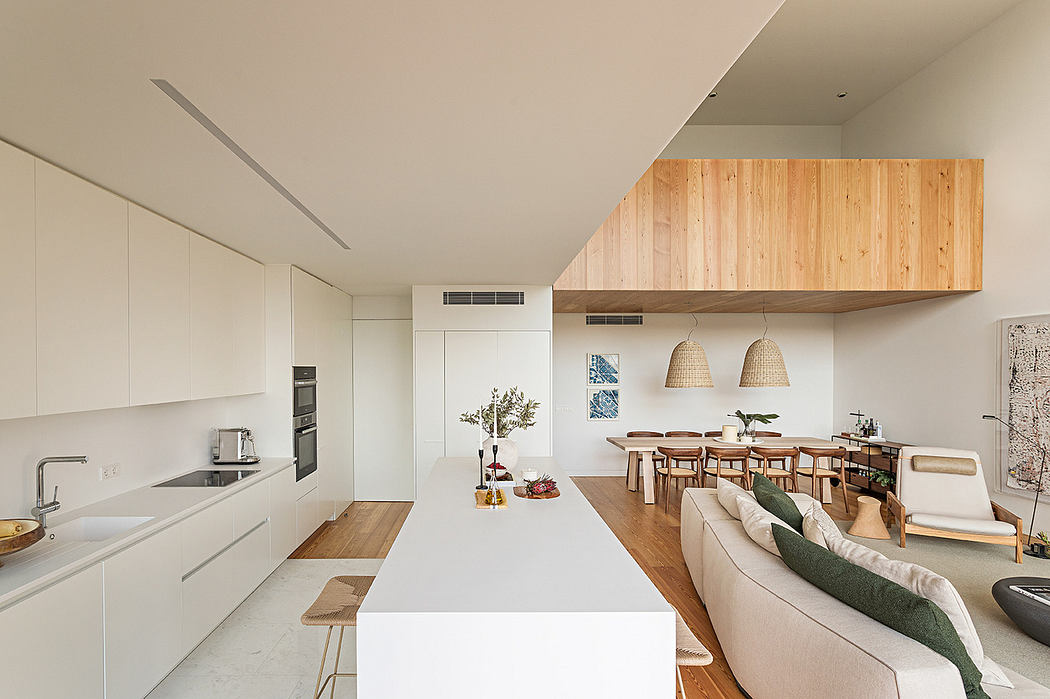 Modern open-plan kitchen and living room with clean lines and wood accents.