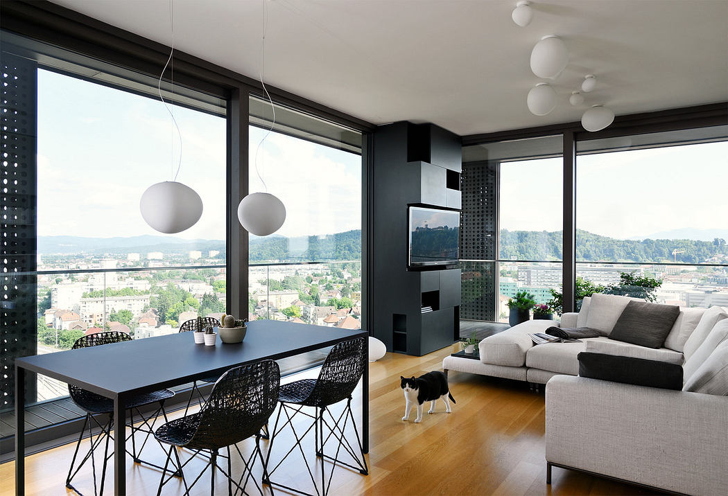 Modern living room with city view, sleek furniture, and a cat.