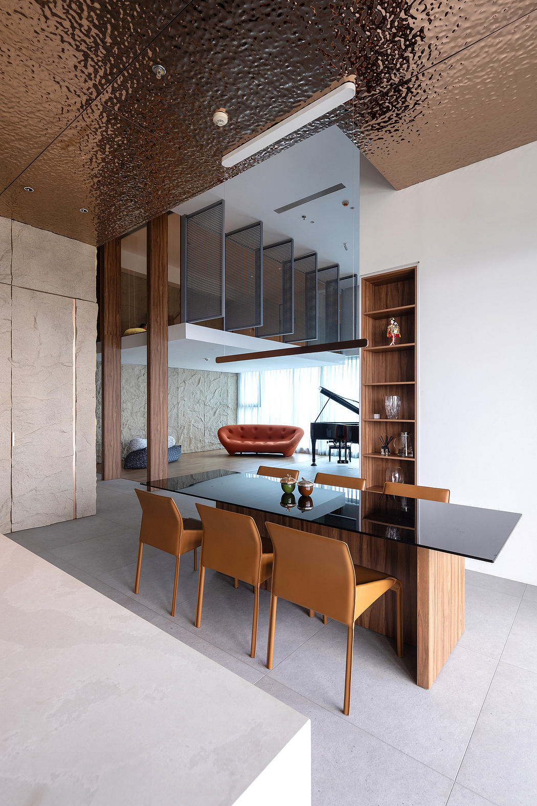Modern dining area with textured ceiling, wooden cabinetry, and sleek chairs.