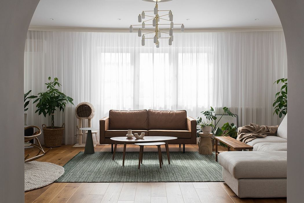 Modern living room with a brown sofa, white curtains, and green area rug.