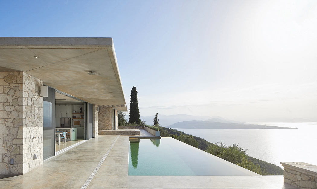Modern seaside villa with infinity pool and expansive view.