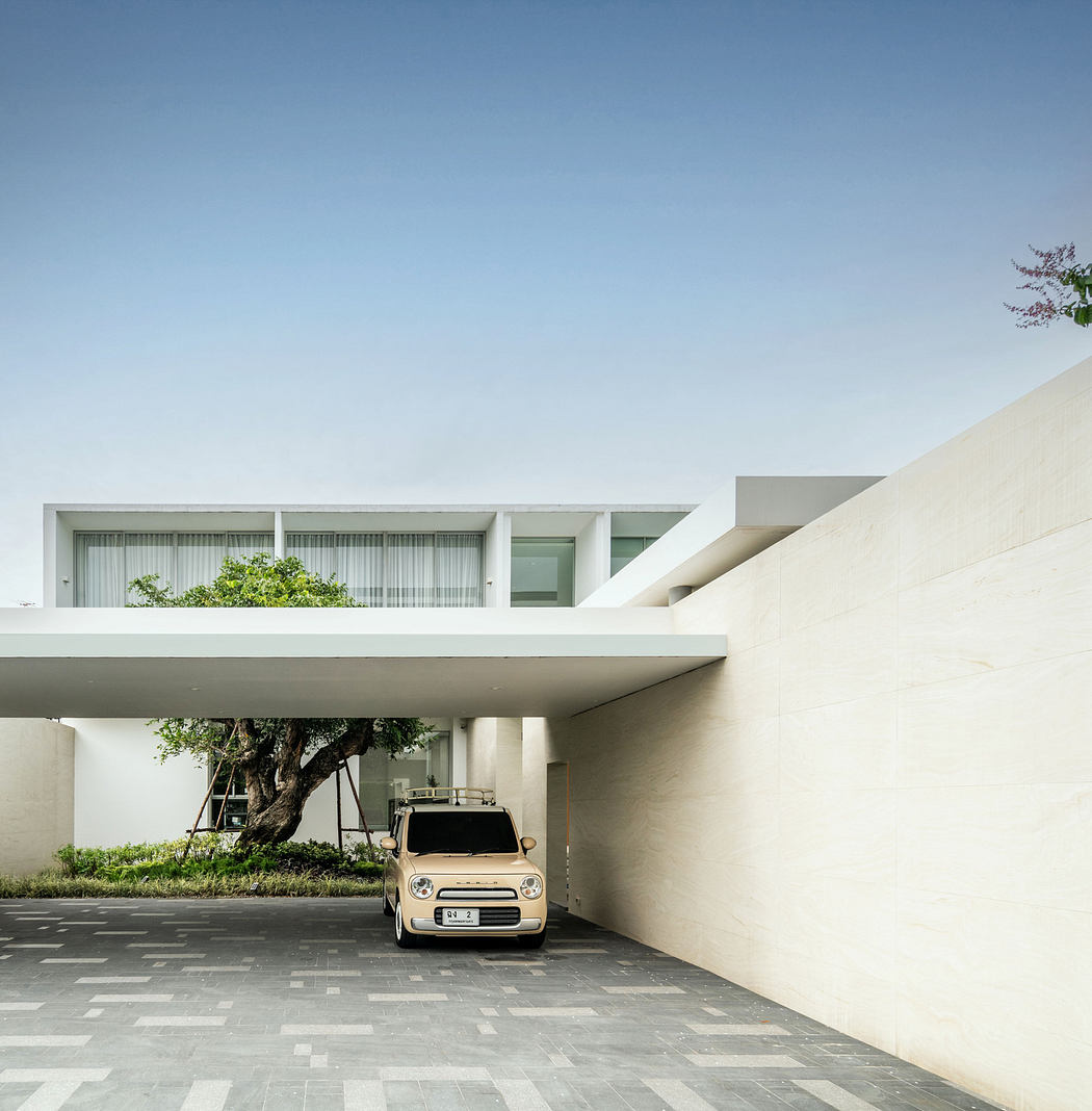 Modern house exterior with clean lines, carport, and balanced geometry.