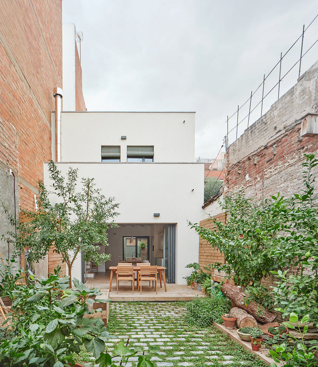 Urban courtyard with garden and contemporary home exterior.