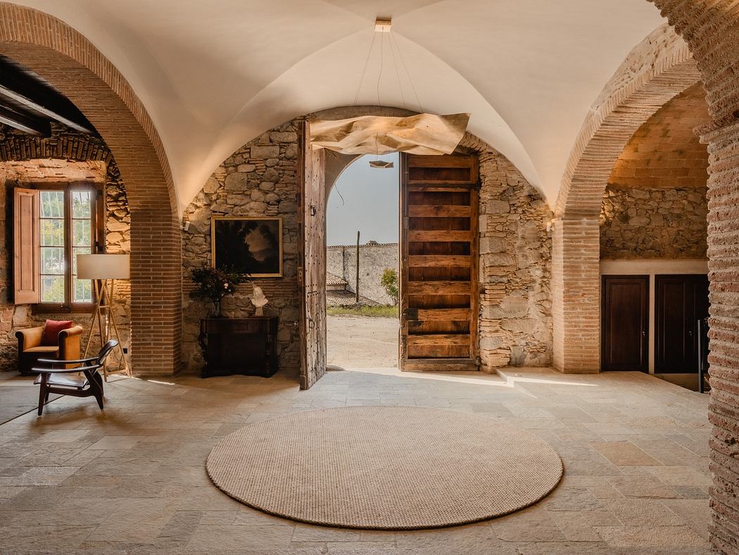 Elegant room with vaulted ceilings, stone walls, and arched wooden doors