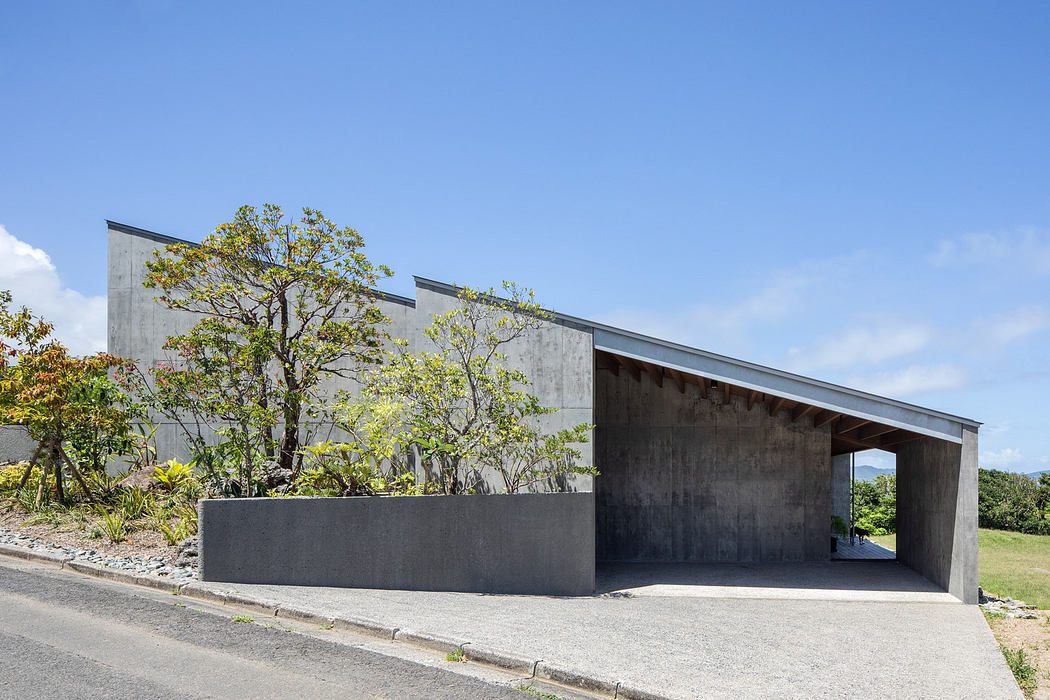 Modern concrete house with a minimalist design and carport.
