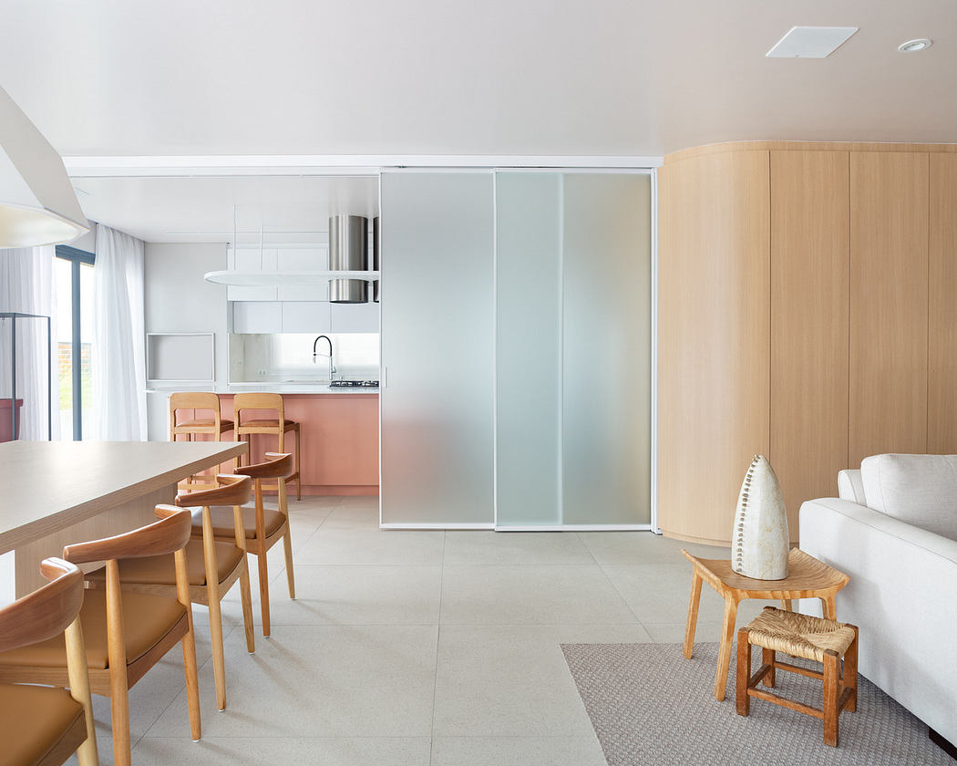 Modern minimalist living room with an open kitchen design.