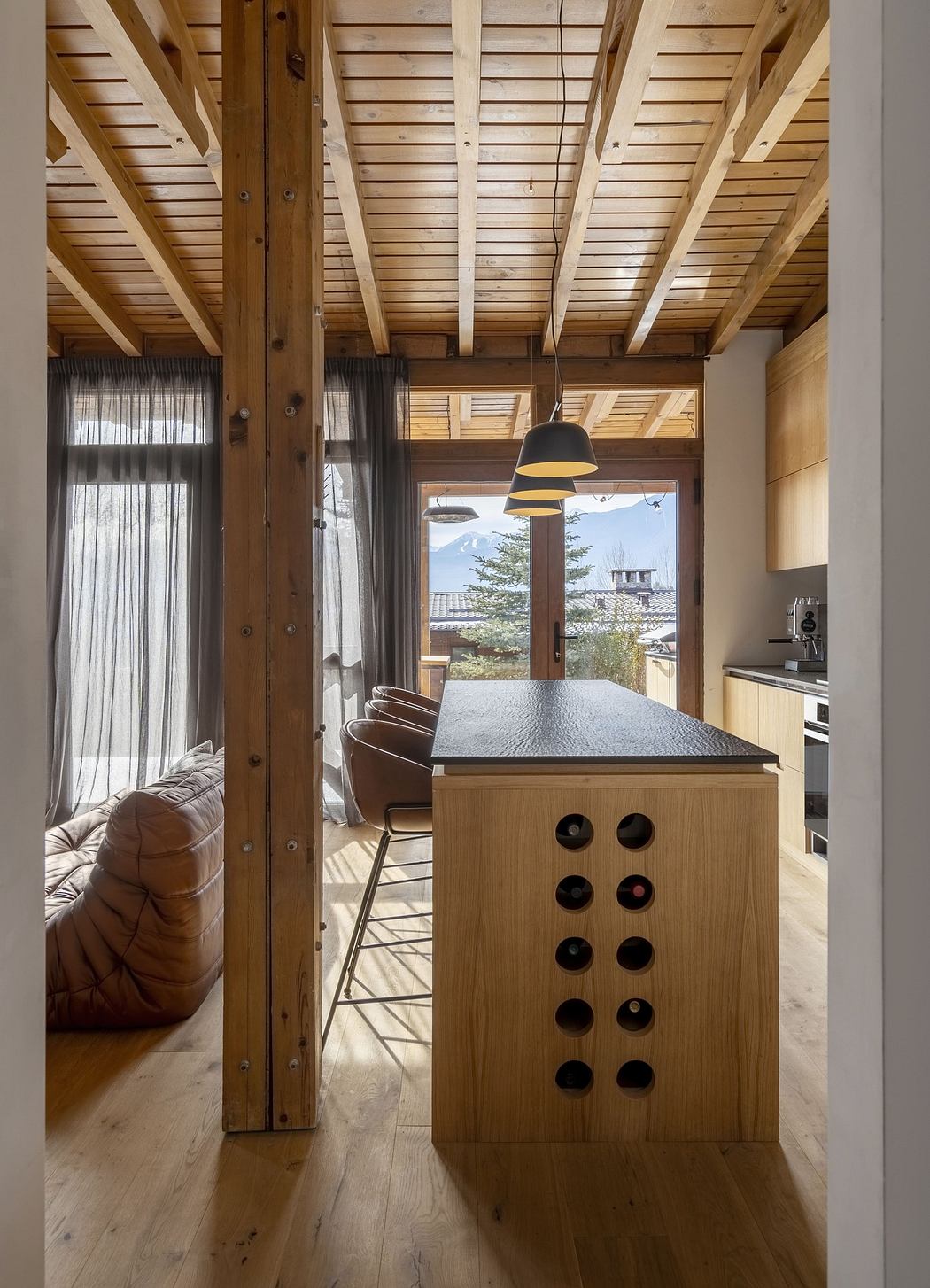 Modern kitchen interior with wooden beams, pendant light, and minimalist design.