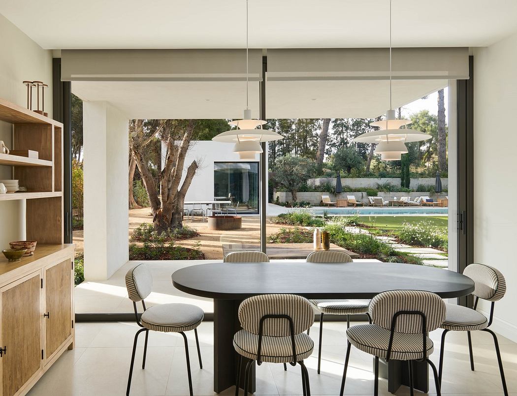 Modern dining room with open view to pool area.