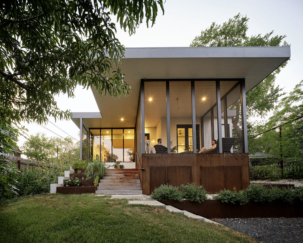 Modern house with large windows, flat roof, and cantilevered porch at