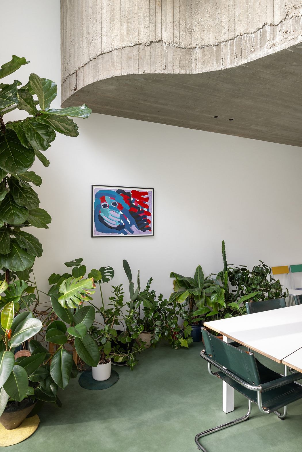 Modern room with plants, artwork, and a ping pong table.