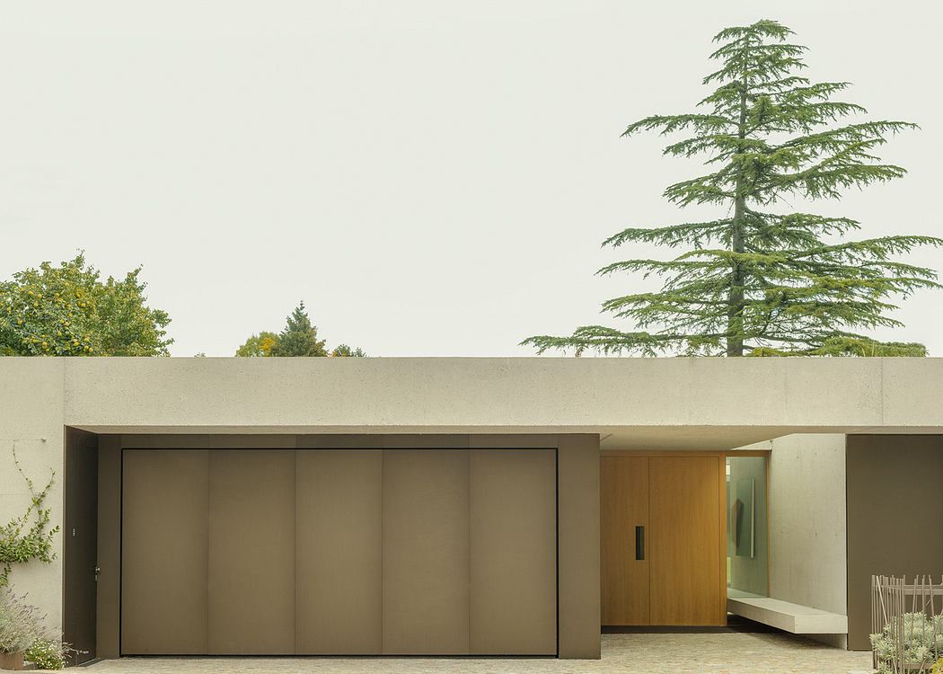 Modern minimalist house facade with large garage door and flat roof.