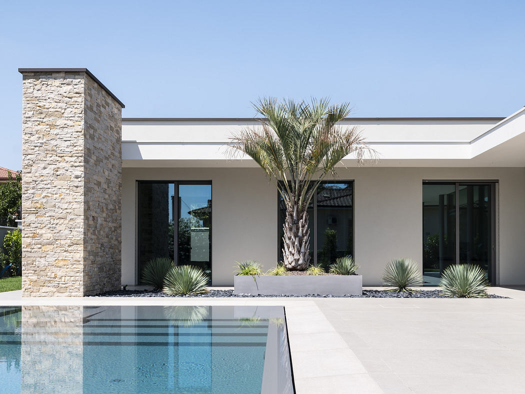 Modern single-story house with stone accents and pool.