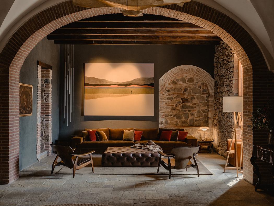 Elegant living room with arched brick ceiling, stone walls, and cozy seating
