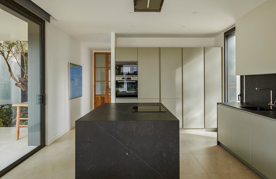 Modern kitchen interior with island and minimalist cabinets.