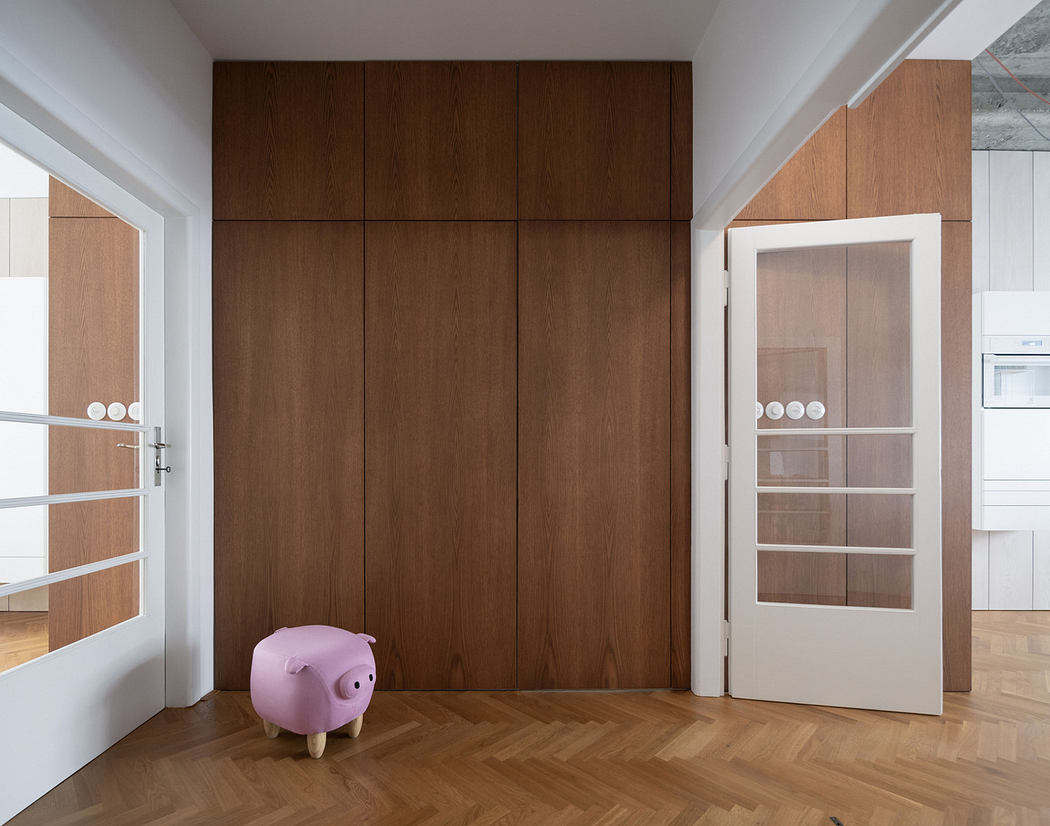 Minimalist room with wooden paneling, herringbone floor, and a pig