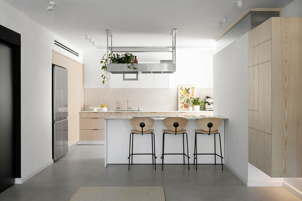 Modern kitchen interior with island and minimalist bar stools.