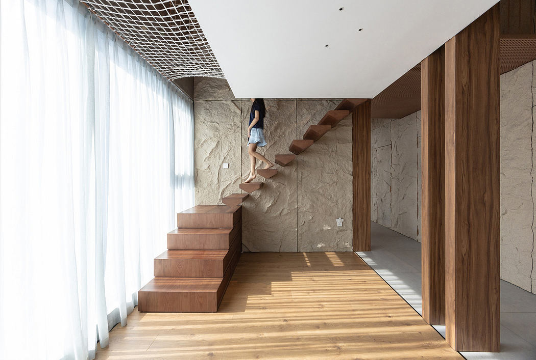 Modern interior with wooden stairs and marble walls.