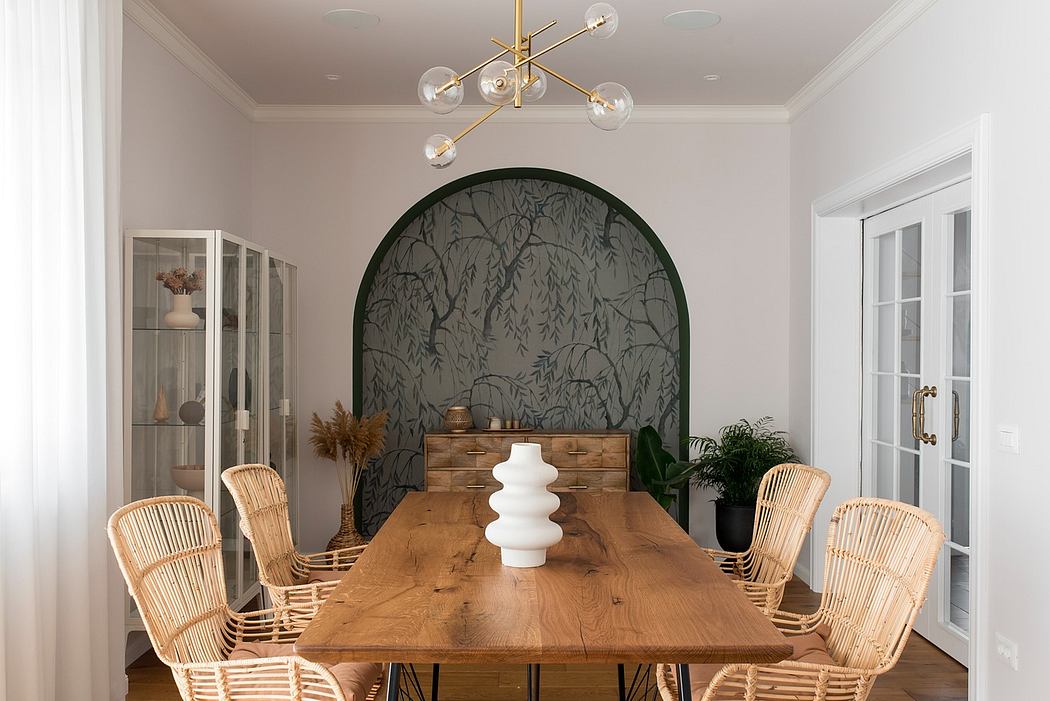 Elegant dining room with wooden table, wicker chairs, and nature-inspired wallpaper