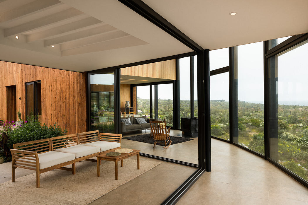 Modern living room with large windows and minimalist furniture.