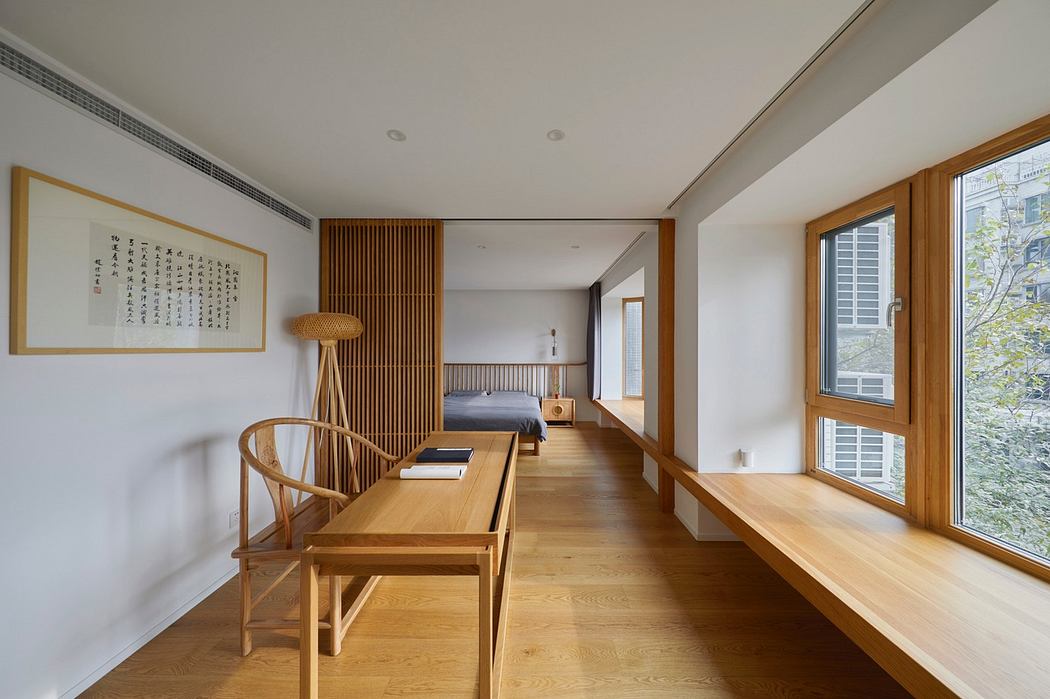 Minimalist interior with wooden furniture and floors, ample natural light.