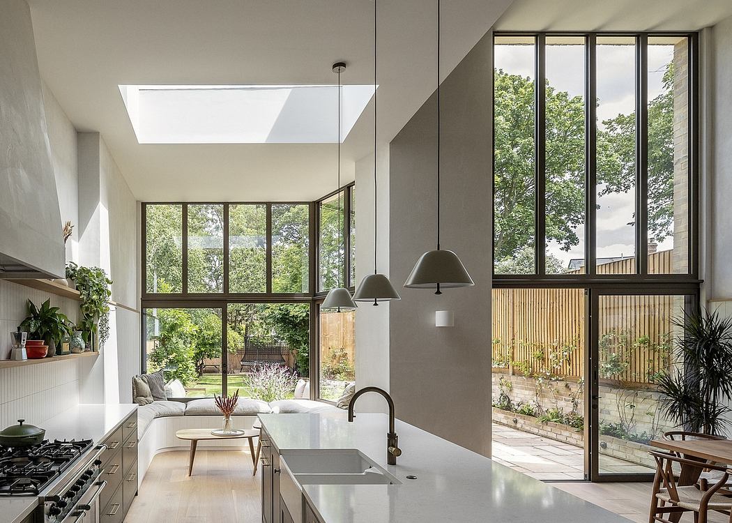 Modern kitchen interior with large windows and skylight.
