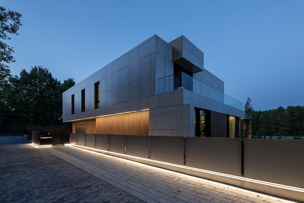 Modern building with geometric design and exterior lighting at dusk.