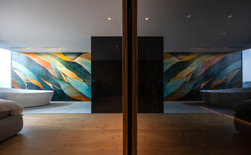 Modern bathroom with vibrant mural, freestanding tubs, and reflective glass division