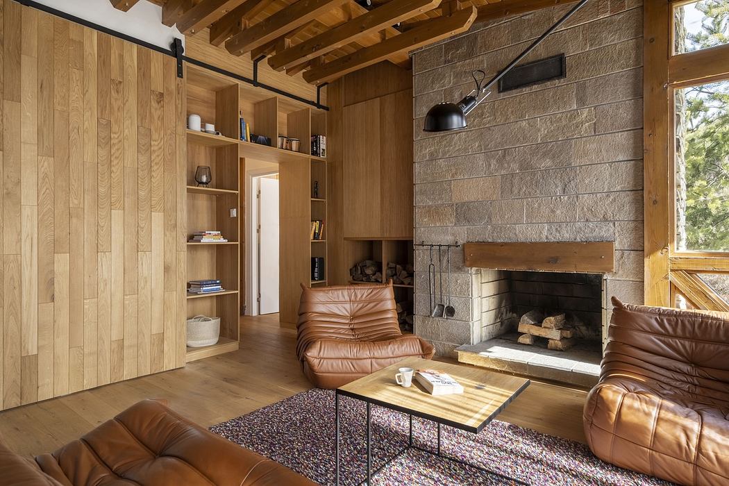 Cozy wooden living room with fireplace and leather furniture.