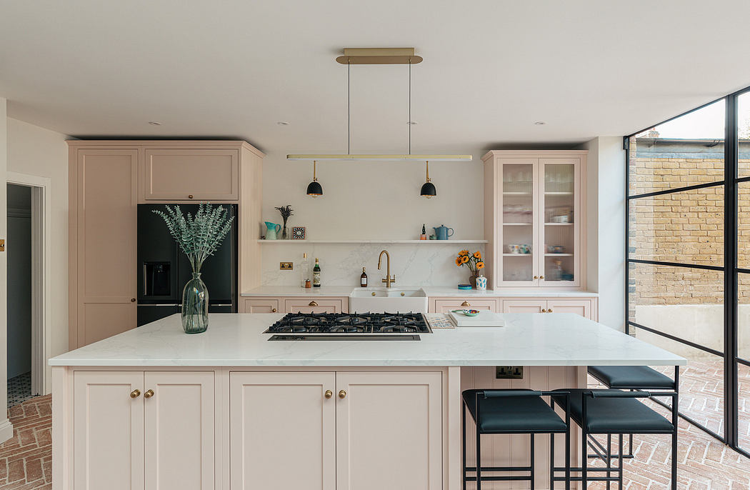 Modern kitchen with pastel cabinetry and central island.