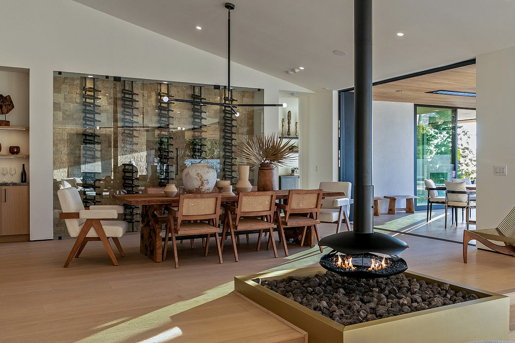 Modern dining room with a central fireplace and open-plan layout.