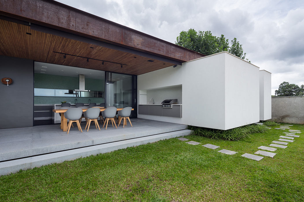 Modern outdoor patio with sleek furniture and stepping stone pathway.