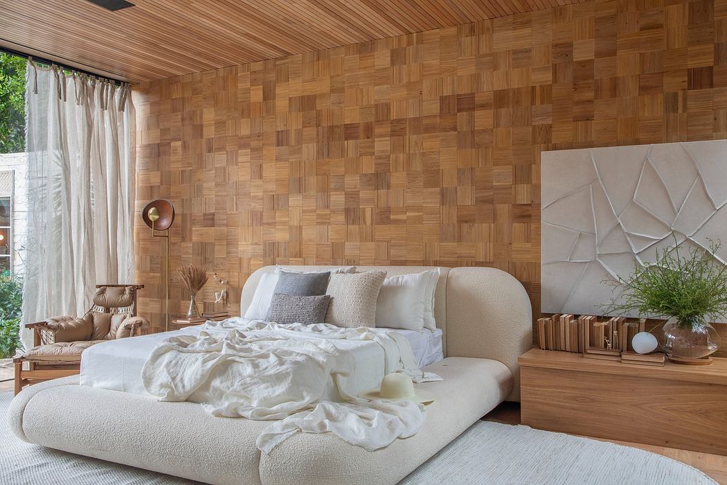 Modern bedroom with wooden wall paneling and textured decor.