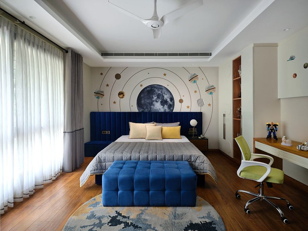 Modern bedroom with space-themed wall decor and a blue bed.