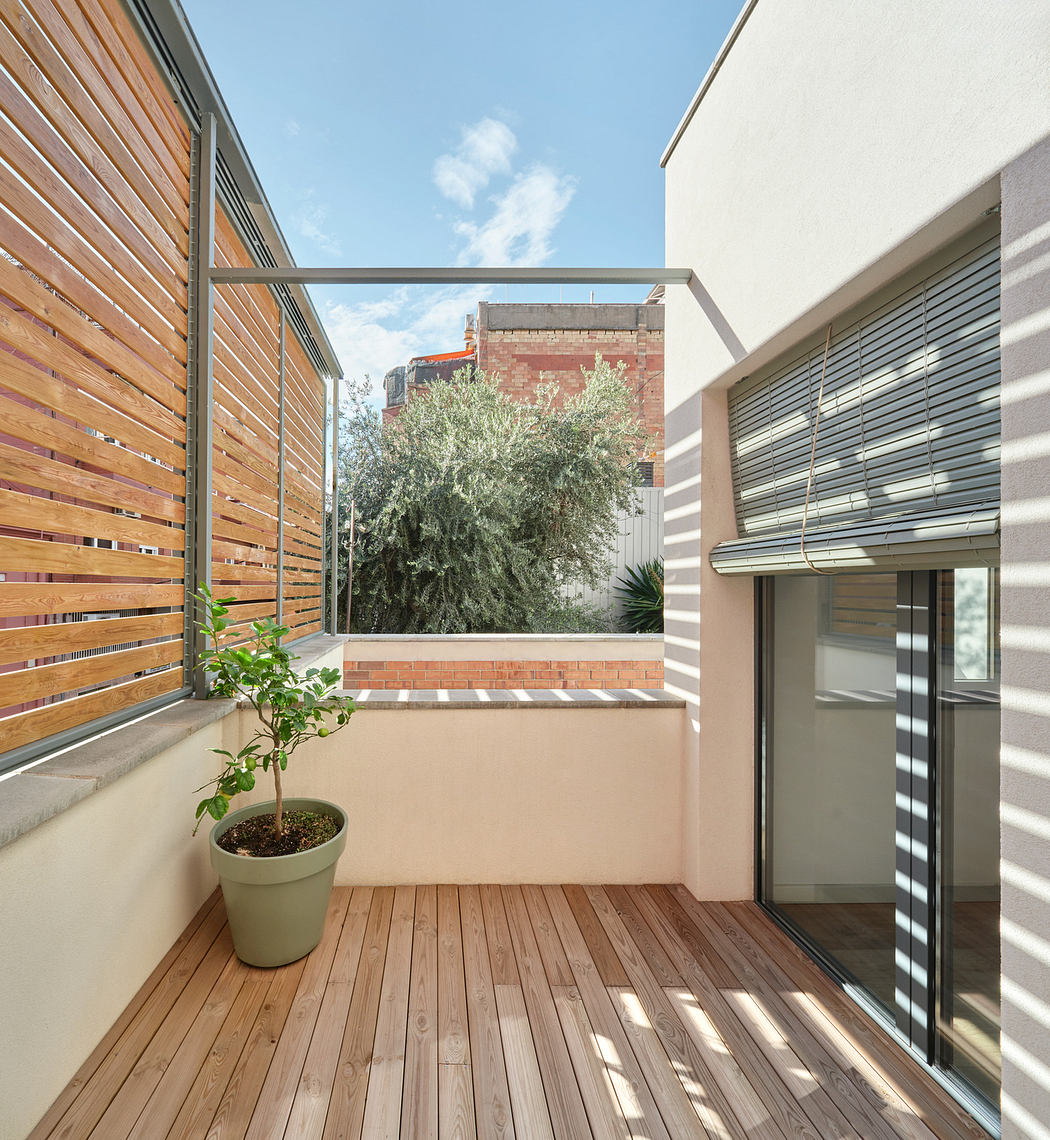 Bright balcony with wooden floor and slatted screens, glass balustrade, and