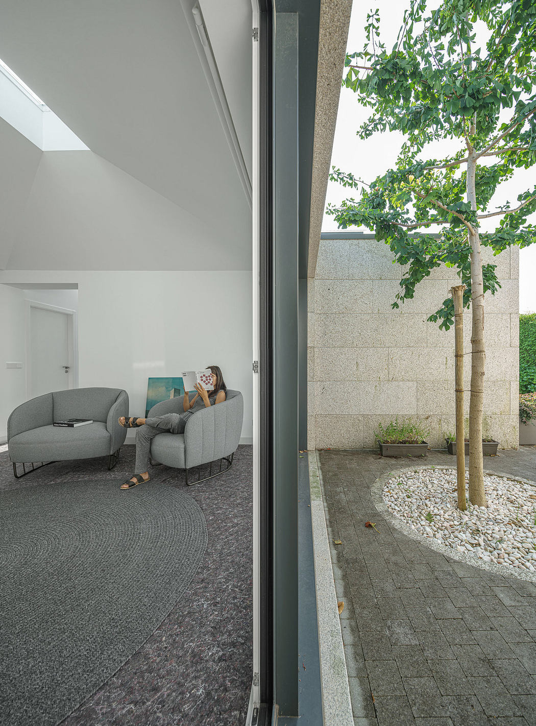 Modern living room with open view to a serene courtyard.
