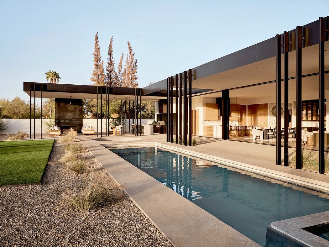 Modern house with large windows, flat roof, and a sleek pool.