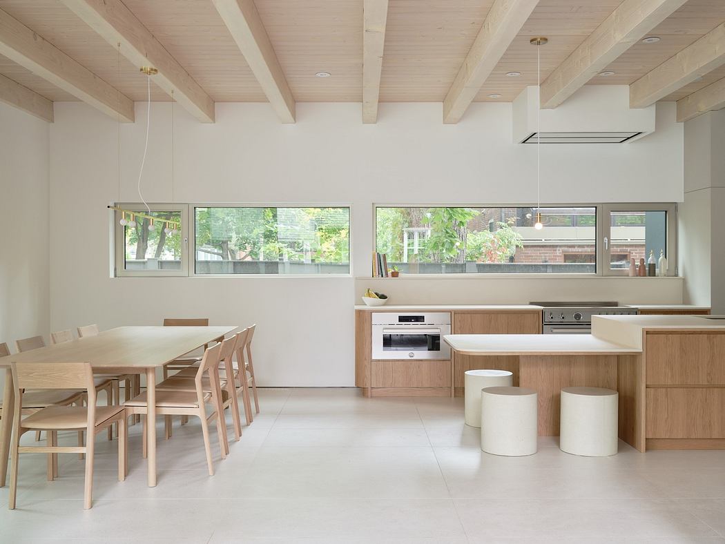 Modern kitchen interior with wooden furnishings and white decor.