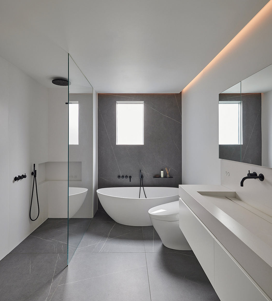 Modern bathroom with a minimalist design, featuring a freestanding tub and sleek fixtures