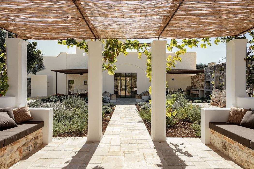 Modern patio with pergola, stone walkway, and built-in seating areas.