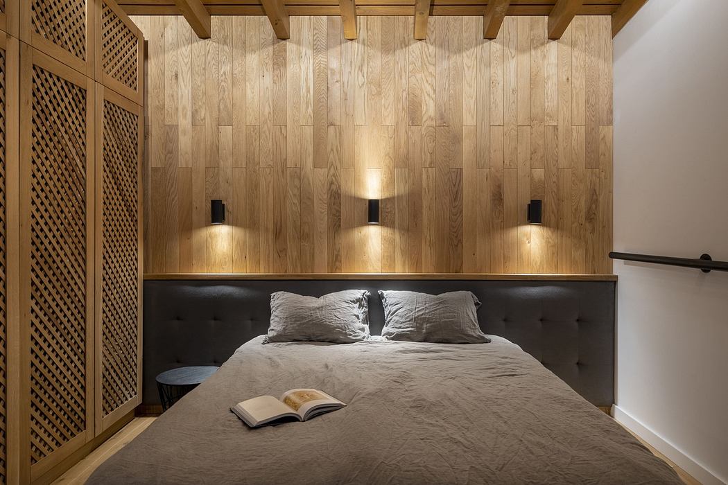 Modern bedroom with wooden walls and pendant lights.