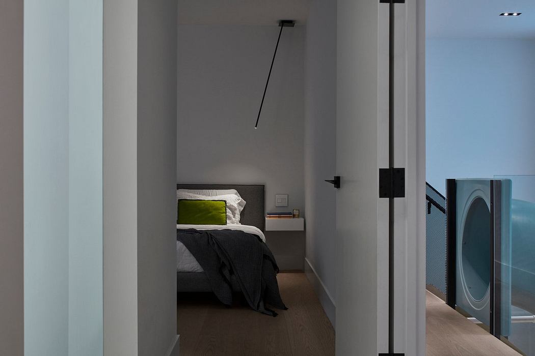 Modern bedroom with minimalist design, neutral tones, and pendant light.