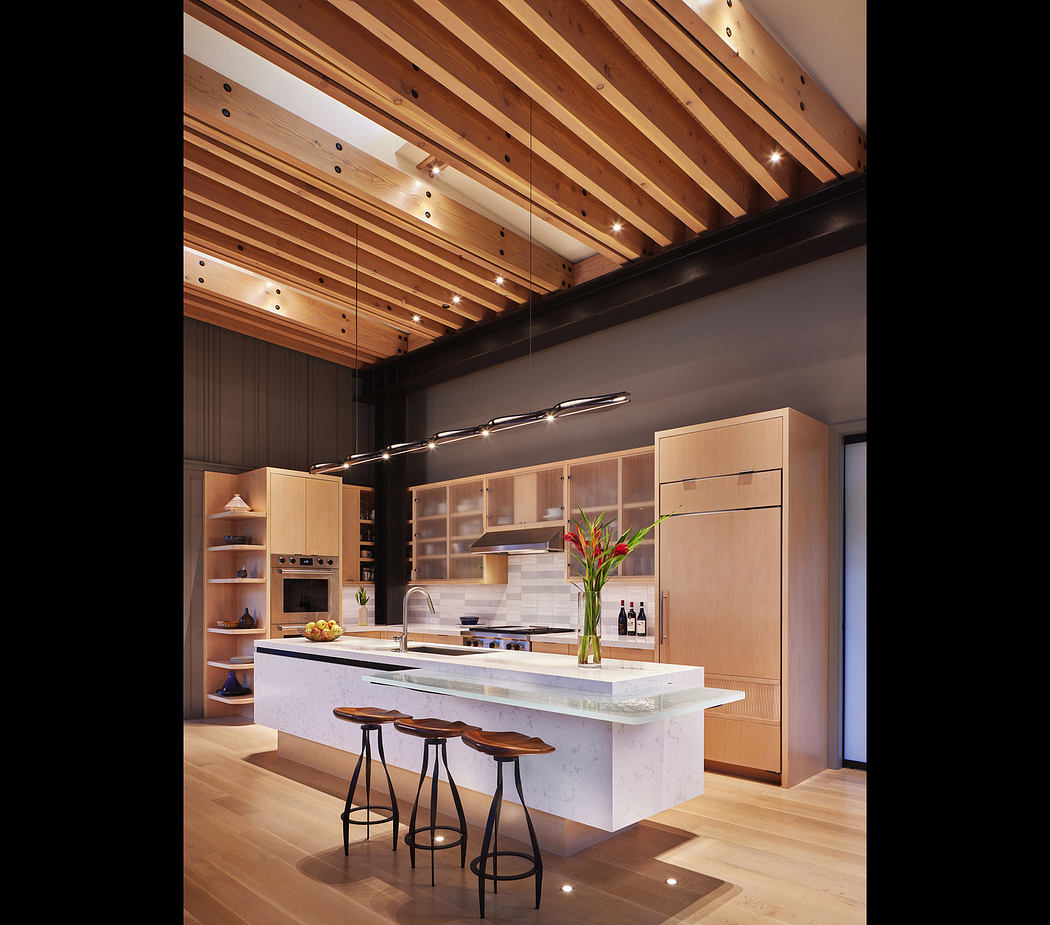 Modern kitchen with a central island, wooden beams, and ambient lighting.