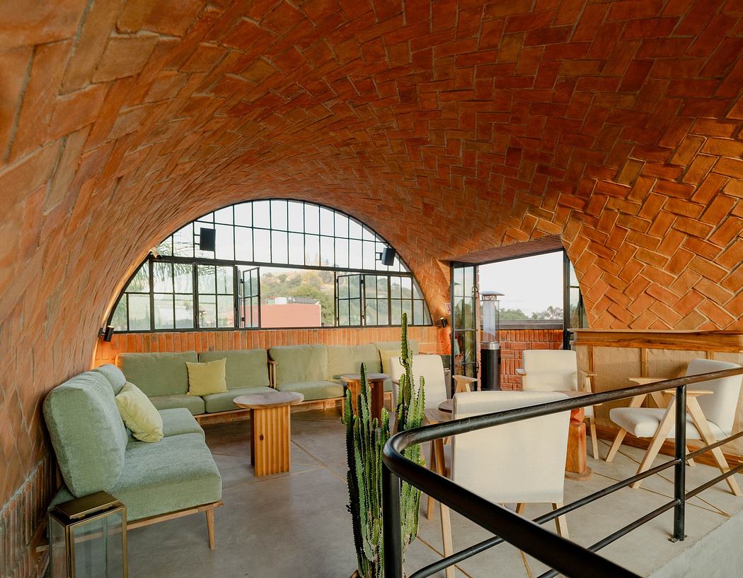 Modern room with arched brick ceiling, large window, and minimalist furniture.