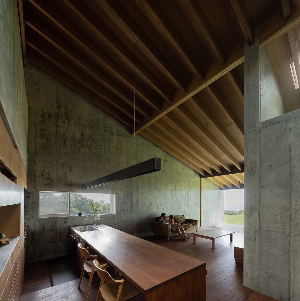 Modern interior with exposed concrete walls, wooden ceiling beams, and minimalist furniture.